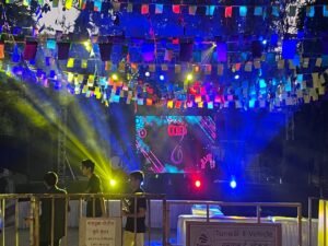 Colorful outdoor event setup of sound and visuals at night